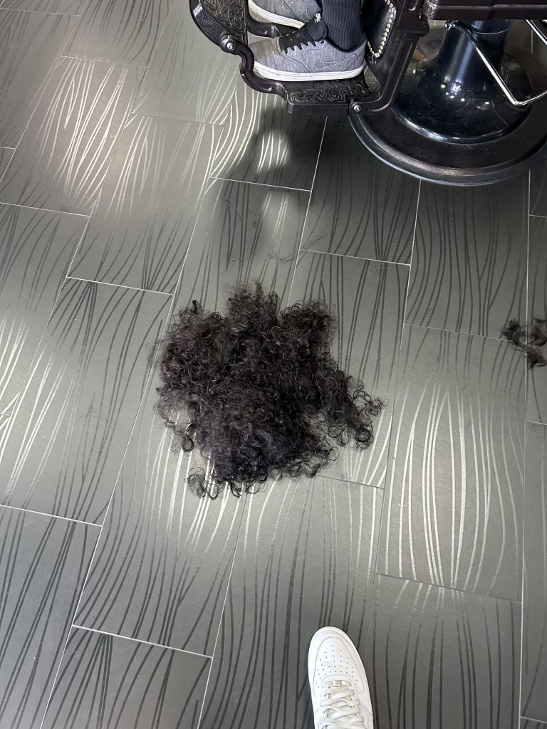 cut hair on barbershop ground