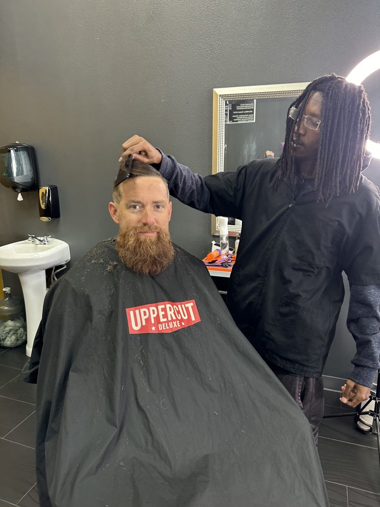 Man with beard getting a haircut