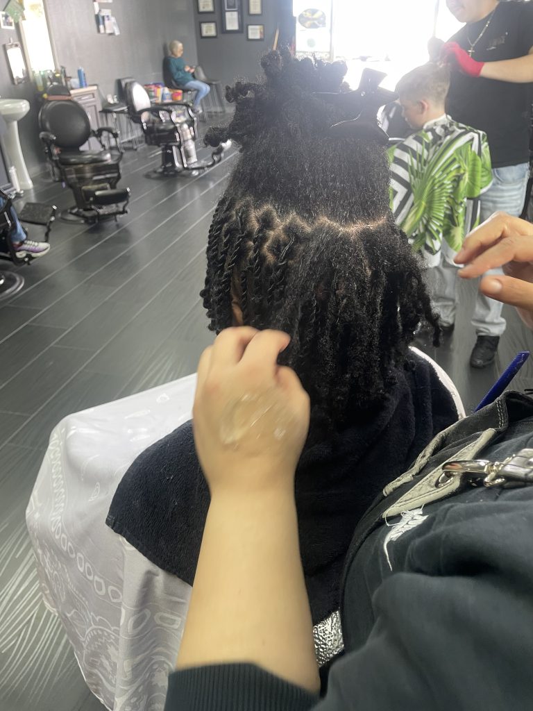 Young man getting dreadlocks