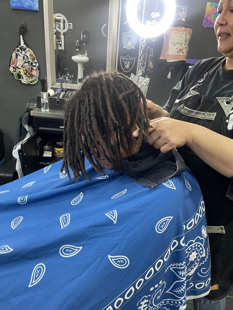 Man with dreadlocks in barbershop